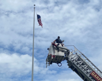Fire Department Repairing Flag at William Foster Elementary