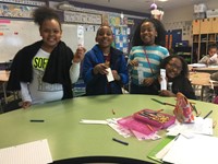 student volunteers creating bookmarks